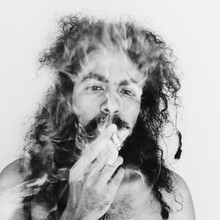 Portrait Of Man With Long Hair Smoking Cigarette