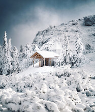 House On Snowcapped Mountain Against Sky