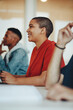 © Jacob Lund - Smiling female student sitting in college classroom
