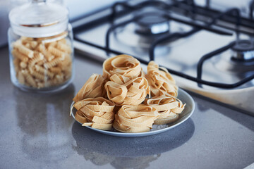 Wall Mural - Spaghetti on the plate and in glass standing on the table at daytime