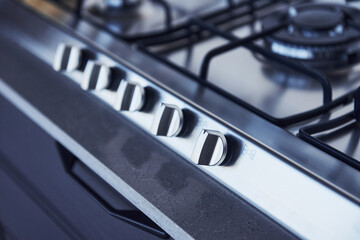 Wall Mural - Close up view of top of a gas stove indoors near wall at daytime