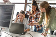 © BalanceFormCreative - Group of team workers and programmers starting a new project.Senior programmer giving help to beginner.
