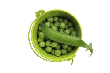 Wall Mural - A small bucket contains a bunch of green peas with one green pea pod