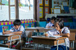 © visoot - Asian elementary students in uniform studying together at classroom,Education,Student,People concept.