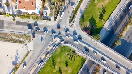 Aerial view of two lane bridge driveway. There is an inner ring road at the bottom. Vehicles and commercial vehicles can also be seen. 
