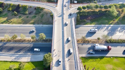 Aerial view of two lane bridge driveway. There is an inner ring road at the bottom. Vehicles and commercial vehicles can also be seen. 