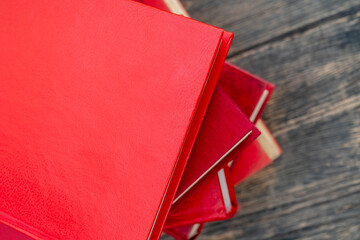 Wall Mural - Top view of a stack of red books on wooden table