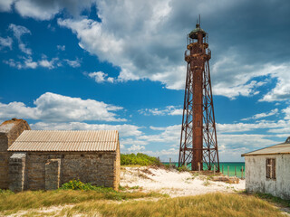 Wall Mural - view to vintage lighthouse between old buildings on the island in Ukraine