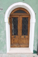 Canvas Print - old wooden door in a stone wall