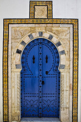 Wall Mural - Vertical shot of a blue door in Sidi Bou Said located in Tunisia