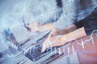 © peshkova - Multi exposure of woman hands typing on computer and financial chart hologram drawing. Stock market analysis concept.