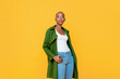 © Atstock Productions - Portrait of smiling young Fashionable African American woman model posing and looking at camera in isolated studio yellow background