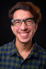 Wall Mural - Portrait of happy young Asian hipster man with curly hair