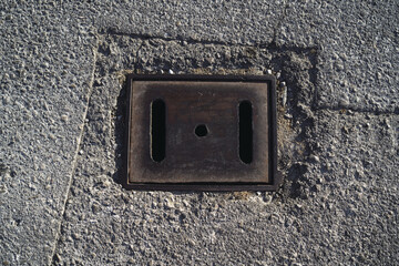 Sticker - Top view of an old outlet on a concrete surface