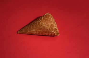 Ice cream waffle cone on red bright background