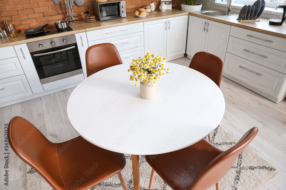 Dining table in interior of modern kitchen