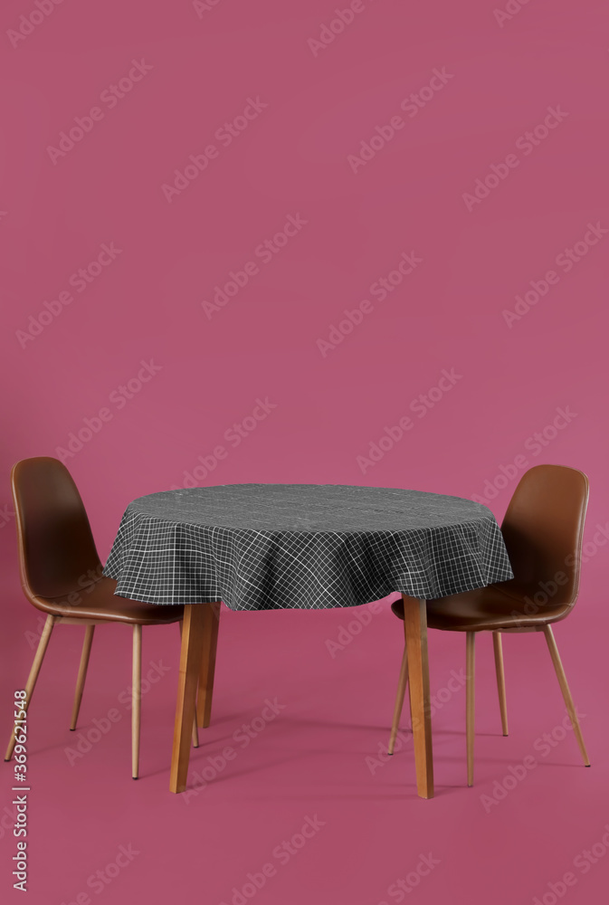 Dining table with chairs on color background