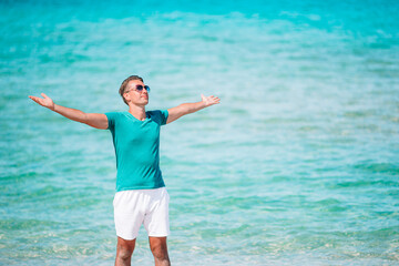 Wall Mural - Young man on the white beach on vacation