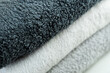 Background of the detail of a terrycloth towels in different shades of gray and white.