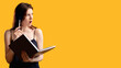 © golubovy - Confused face. Excited woman thinking on question. Isolated on orange free space. Solve problem concept. Brain storming