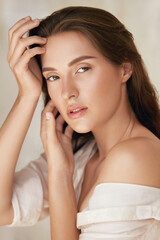 woman. beauty portrait of young model touching face. beautiful brunette with natural makeup and perf