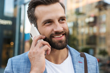 Wall Mural - Young urban businessman on smart phone