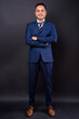 © Ranta Images - Portrait of happy young handsome Indian businessman in suit