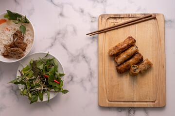 Wall Mural - High angle closeup shot of Asian rolls on a wooden board