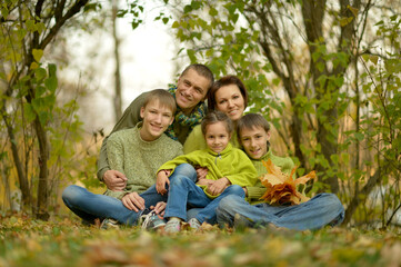 Wall Mural - Portrait of family relaxing in autumn park