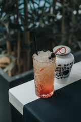 Poster - Vertical shot of refreshing summer cocktail with ice on a bar table