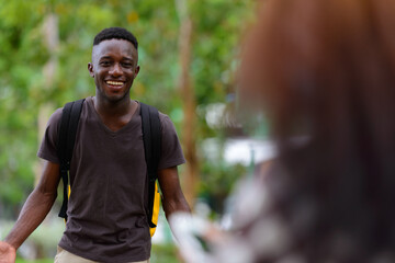 Young African man and young woman with red hair together