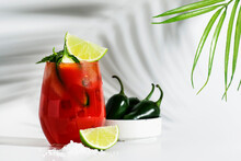 Spicy Alcoholic Cocktail With Vodka, Tomato Juice, Jalapeno Pepper, Lime And Salt, White Background, Hard Light, Copy Space