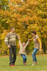 Poster - Happy smiling family relaxing in autumn park