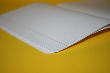 a paper new notebook on a yellow background