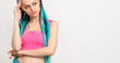 © golubovy - Pensive woman with blue braids ethnic hairstyle. Portrait of thoughtful lady in pink with bright dyed dreads isolated on white copy space. Hipster lifestyle. Professional creative hairdressing.