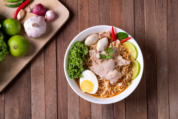 Wall Mural - instant Noodles with Sliced pork in Creamy Tom Yum soup