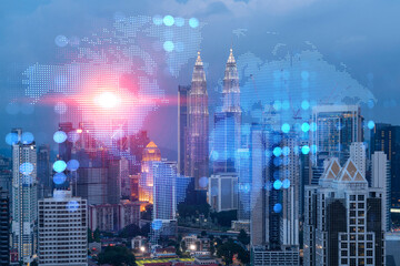 Hologram of Earth planet map on night panoramic cityscape of Kuala Lumpur, Malaysia, Asia. The concept of international companies in KL. Multi Exposure.