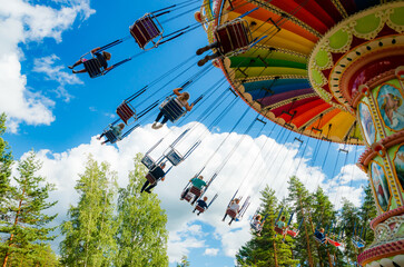 Wall Mural - Kouvola, Finland - 14 July 2020: Ride Swing Carousel in amusement park Tykkimaki at summer sunny day