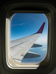 Wall Mural - Airplane wing from the porthole window.