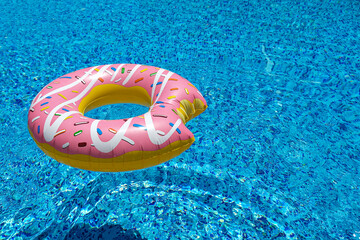 Poster - pink inflatable donut doughnut floating mattress in swimming pool. Beach pool accessories. Summer holiday concept
