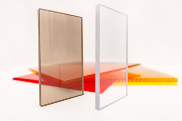 Solid Polycarbonate Sheet. Brown and transparent. Acrylic Plastic glass. Colored pc sheet on background