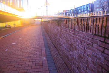 Sunset in the Netherlands, the sun is almost going down showing the last rayes of sunlight seen from a bicicle path in the Netherlands