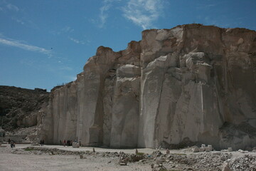 A large cliff of soft rock that results from a mining place of lime stone