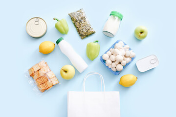 Wall Mural - Set of grocery items from canned food, vegetables, cereal on blue background. Food delivery concept. Donation concept. Top view.