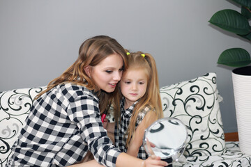 Poster - Lifestyle portrait of mom and daughter in happy home