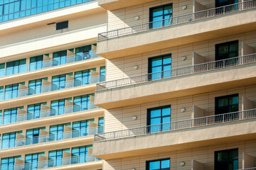 Fragment of a high-rise building with Windows and balconies