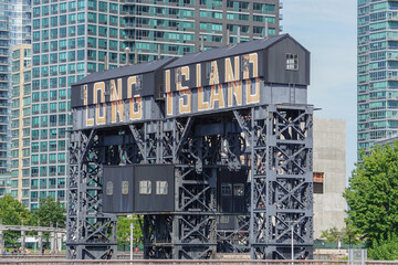 Long Island City, New York: Vintage railroad gantry with large sign in Gantry Plaza Park.