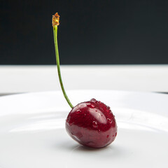 juicy cherry berries lie on a white plate. healthy food for breakfast. fruits of vegetation. fruit dessert