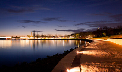 the illuminated path along the waters of lake burley griffin in canberra, australian capital territo
