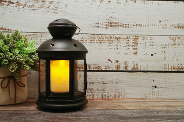 Black Lantern decorative with candles with space copy on wooden background